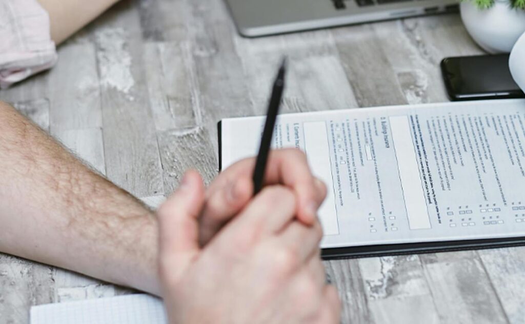 Preparing Employees for Government Contract Work Environments Employee reviewing onboarding and compliance documents for government contract workforce readiness